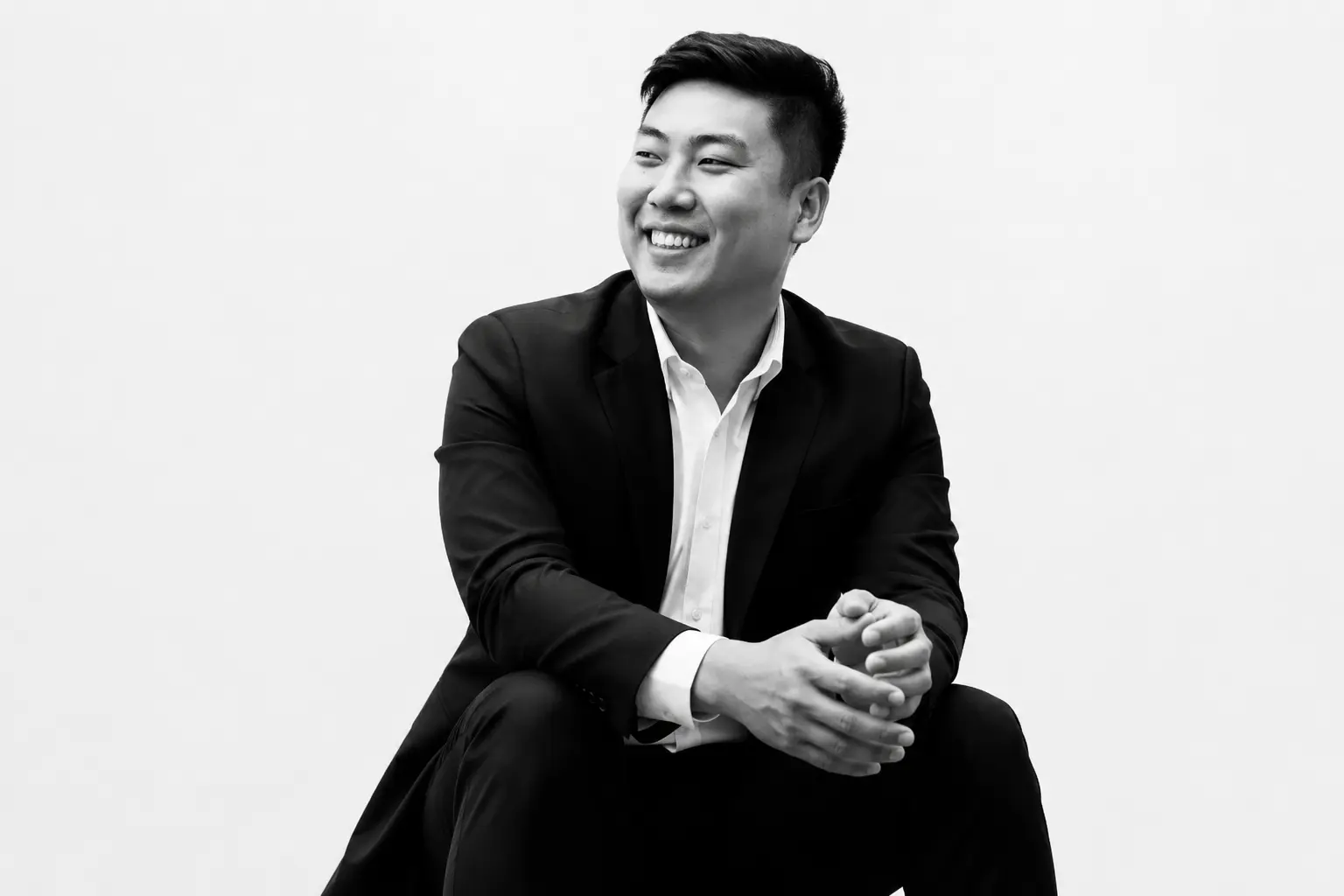 Rayner Teo seated in a black and white portrait photograph